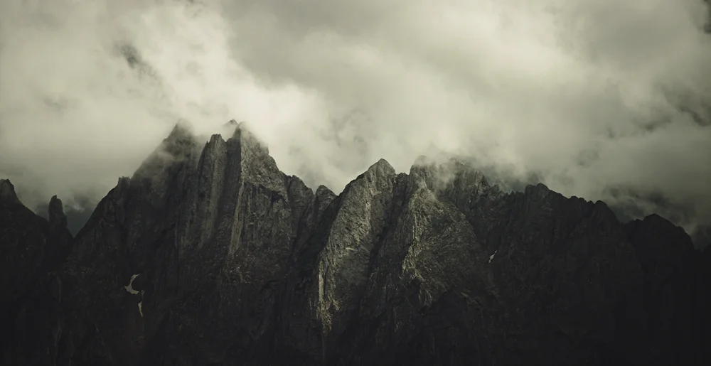 Dramatic mountain peaks beneath low clouds
